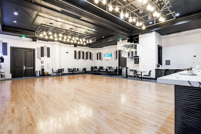 interior space featuring wood-type flooring and a high ceiling