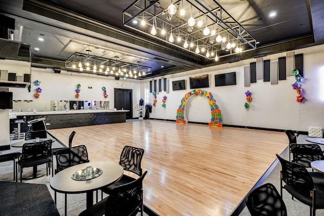 interior space featuring wood-type flooring and a chandelier