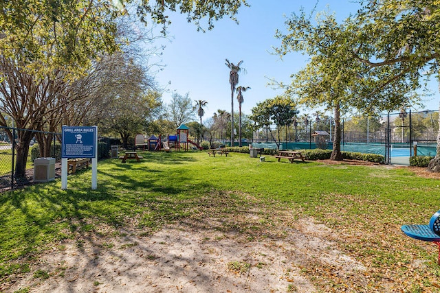 view of yard featuring a playground and tennis court