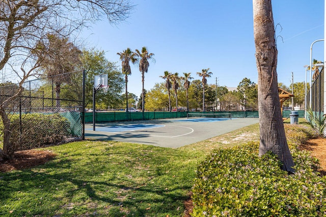 view of sport court featuring a lawn