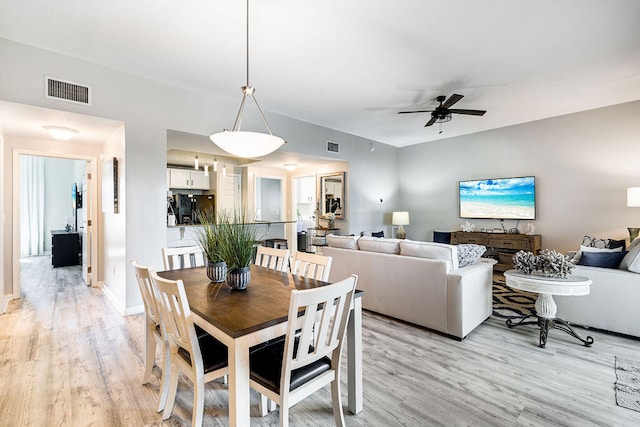 dining space featuring light hardwood / wood-style floors and ceiling fan