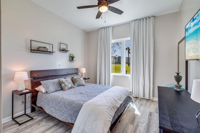 bedroom with ceiling fan and light wood-type flooring