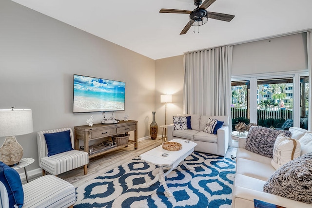 living room featuring light hardwood / wood-style floors and ceiling fan