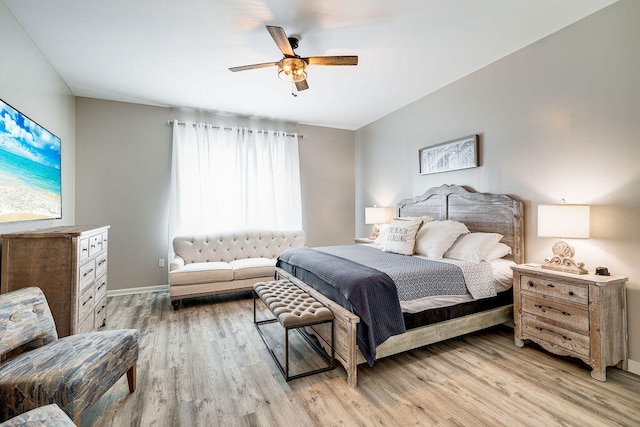 bedroom with light hardwood / wood-style flooring and ceiling fan