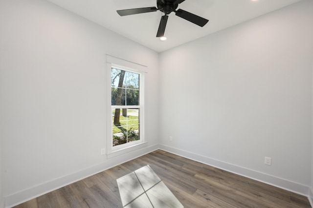 spare room with ceiling fan and dark wood-type flooring