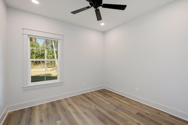 empty room with ceiling fan and hardwood / wood-style floors