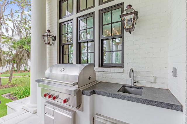 view of terrace with sink, area for grilling, and an outdoor kitchen