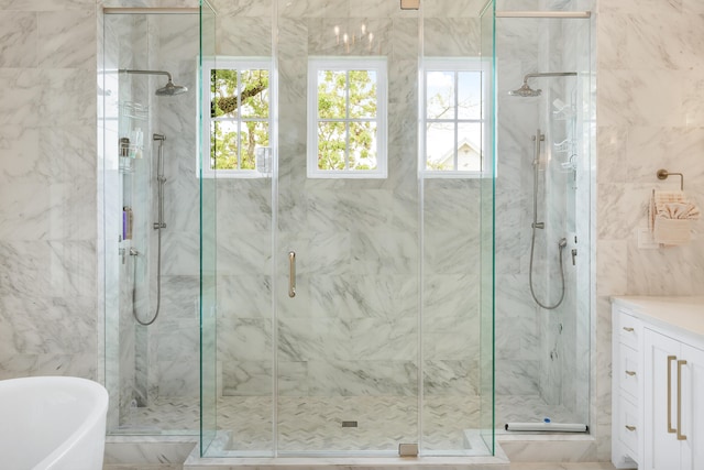 bathroom with tile flooring, tile walls, separate shower and tub, and vanity