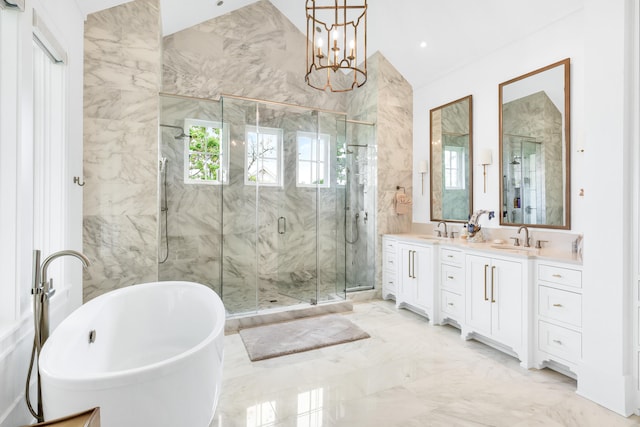 bathroom featuring tile walls, independent shower and bath, tile flooring, an inviting chandelier, and dual vanity