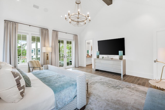 bedroom with high vaulted ceiling, french doors, access to outside, dark wood-type flooring, and an inviting chandelier