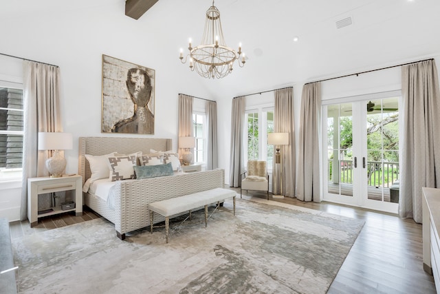 bedroom with hardwood / wood-style floors, french doors, a chandelier, and access to exterior