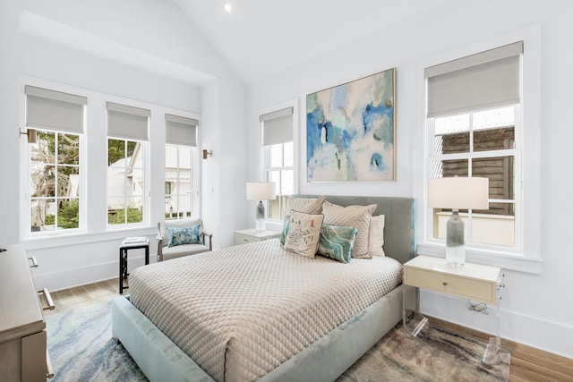 bedroom featuring wood-type flooring and lofted ceiling