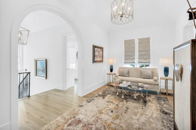 sitting room with a notable chandelier and light hardwood / wood-style floors