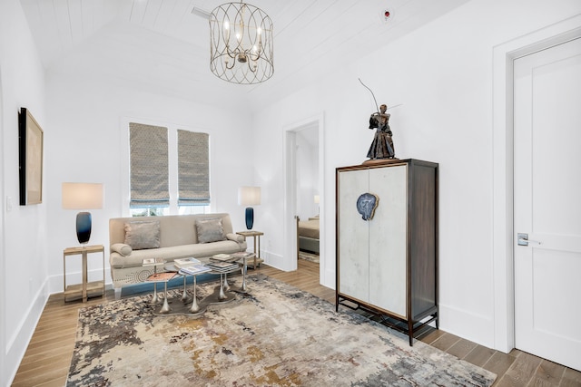 living area featuring hardwood / wood-style floors and a chandelier