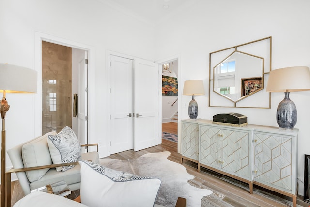 sitting room with light wood-type flooring and a chandelier