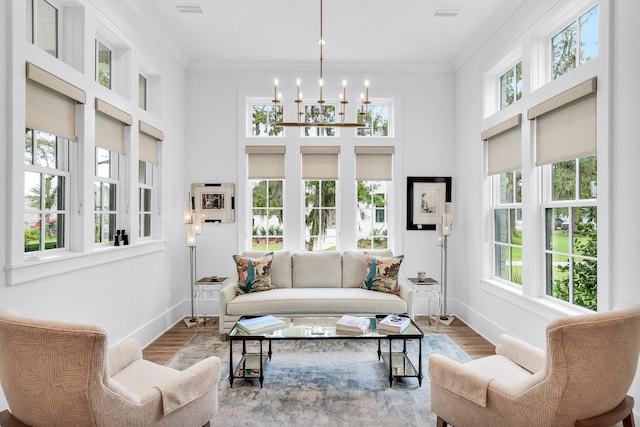 interior space featuring light hardwood / wood-style floors, an inviting chandelier, and crown molding