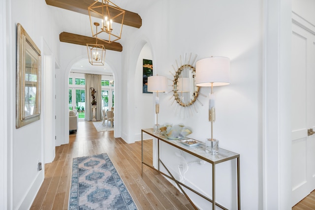 foyer entrance featuring light hardwood / wood-style flooring and a chandelier