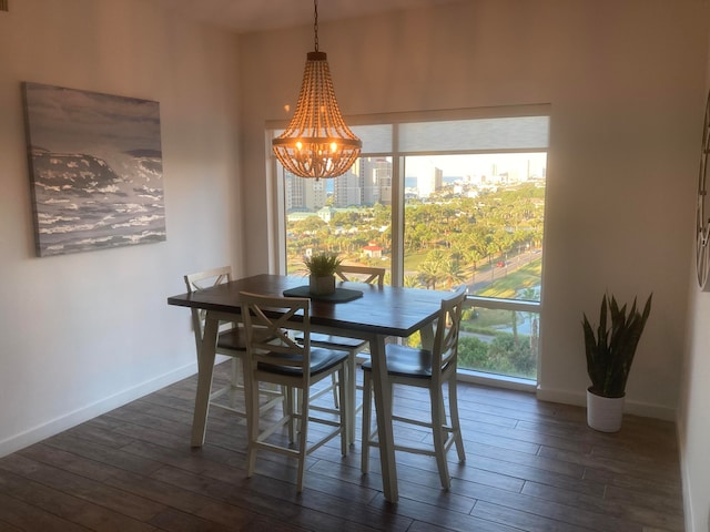 dining room with an inviting chandelier and dark wood-type flooring