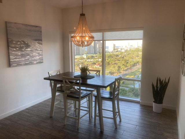 dining room featuring dark wood-type flooring and a chandelier