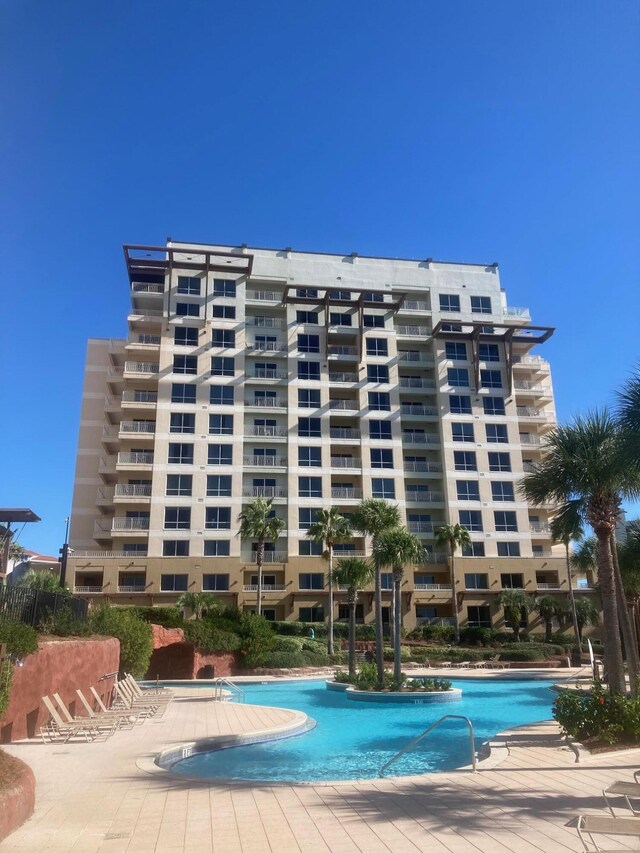 view of building exterior featuring a community pool