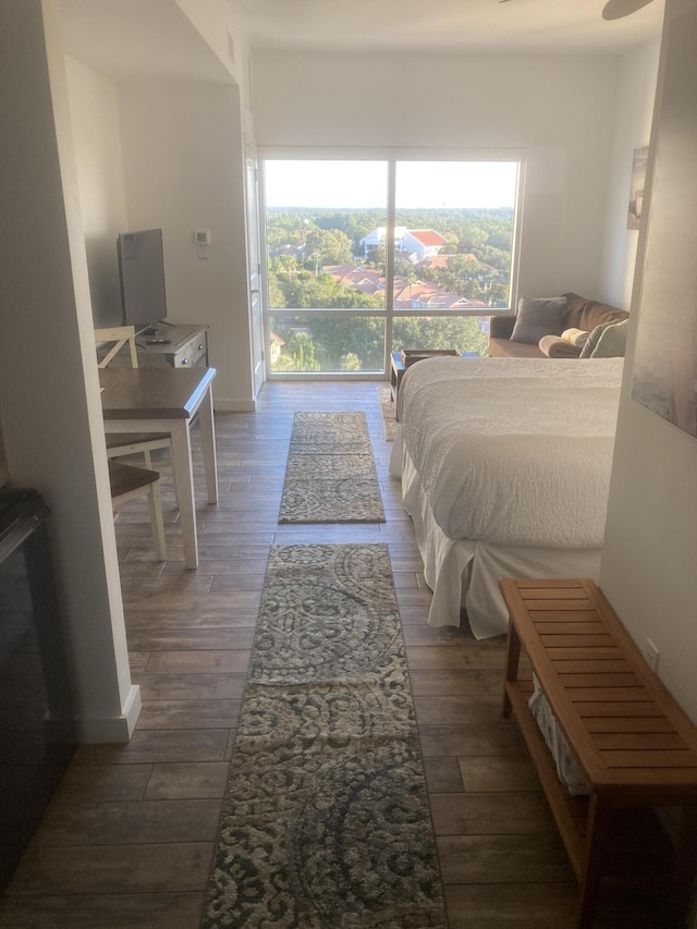 bedroom with dark hardwood / wood-style flooring