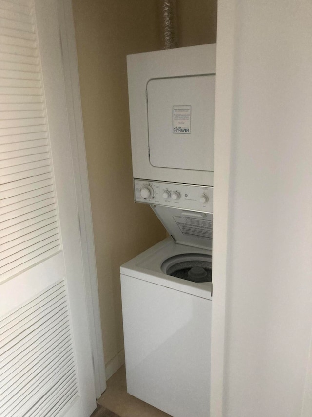 washroom with stacked washer and dryer