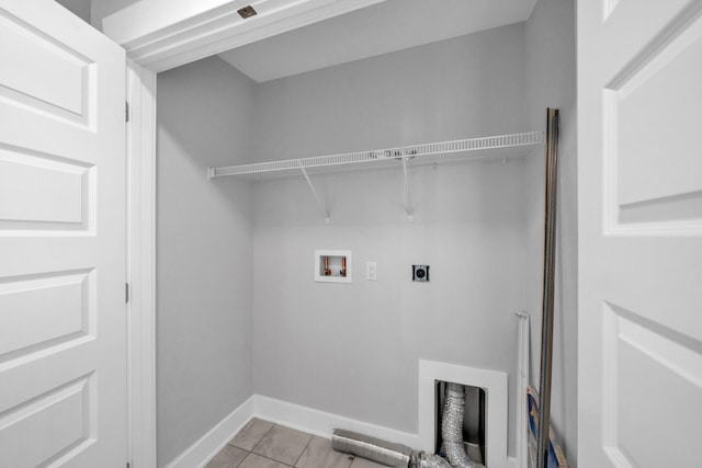 laundry room with hookup for an electric dryer, light tile flooring, and washer hookup