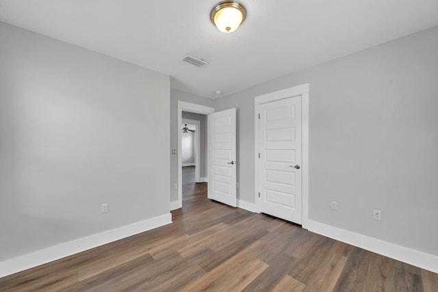 unfurnished room featuring dark hardwood / wood-style flooring