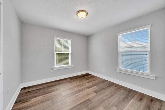 empty room with hardwood / wood-style flooring