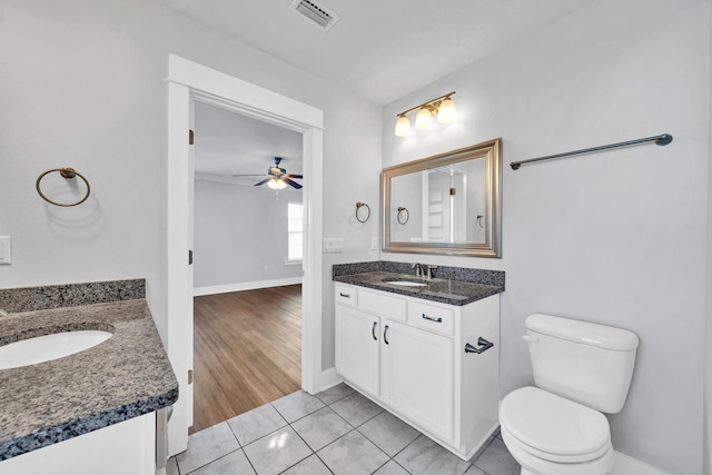 bathroom with hardwood / wood-style floors, ceiling fan, toilet, and vanity