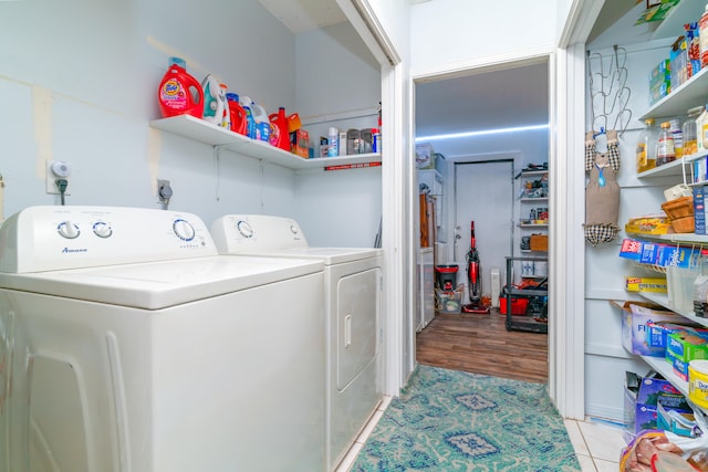 laundry room with hookup for an electric dryer, light wood-type flooring, and separate washer and dryer