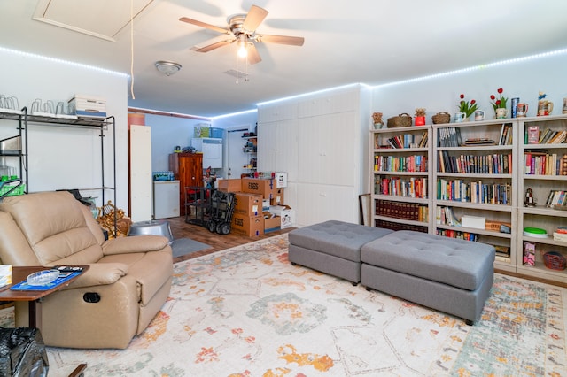 living room with ceiling fan and light wood-type flooring