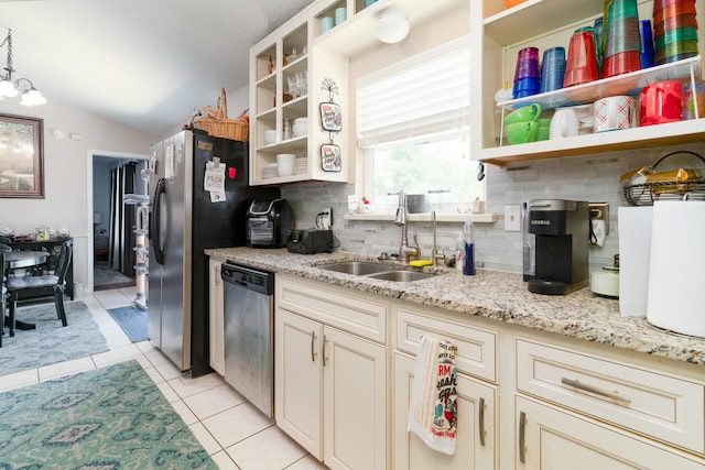 kitchen with sink, tasteful backsplash, stainless steel dishwasher, vaulted ceiling, and light stone countertops