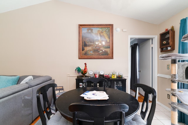 tiled dining room with lofted ceiling