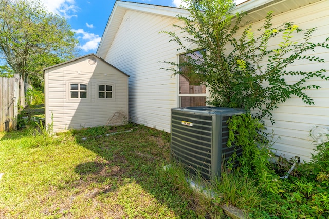 exterior space featuring central air condition unit and a lawn