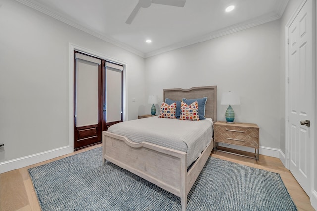 bedroom with ornamental molding, light hardwood / wood-style flooring, french doors, and ceiling fan