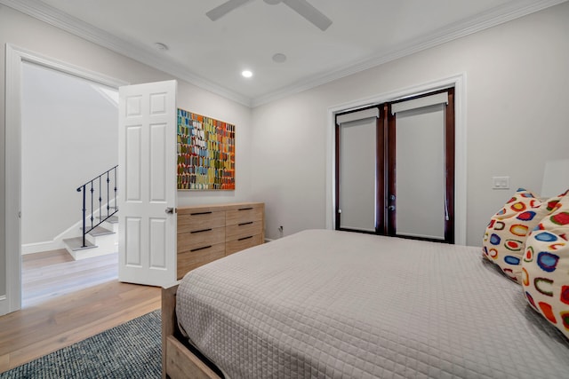 bedroom featuring ornamental molding, light hardwood / wood-style flooring, and ceiling fan