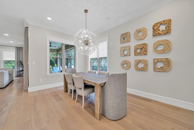 dining room featuring plenty of natural light, a notable chandelier, and light hardwood / wood-style floors