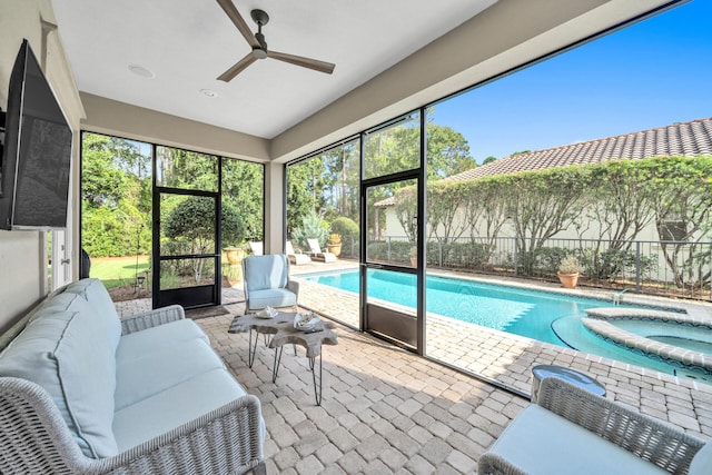 sunroom featuring ceiling fan