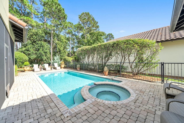 view of swimming pool featuring an in ground hot tub and a patio