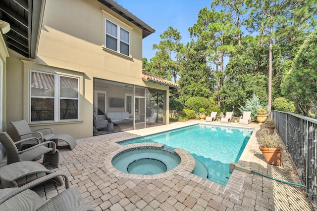 view of swimming pool with a patio area and an in ground hot tub