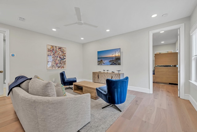 living room featuring ceiling fan and light wood-type flooring