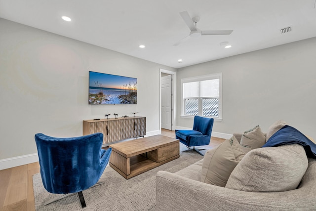 living room featuring ceiling fan and light hardwood / wood-style flooring