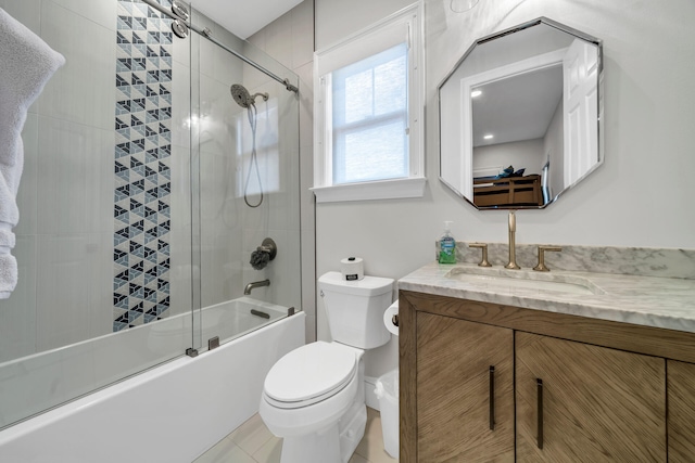 full bathroom featuring tile floors, vanity, toilet, and shower / bath combination with glass door