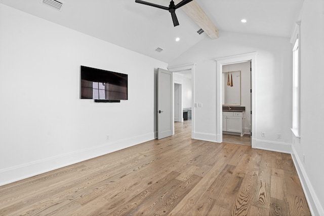 unfurnished bedroom featuring ceiling fan, ensuite bath, lofted ceiling with beams, and light wood-type flooring