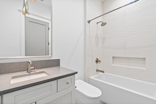 full bathroom featuring vanity, toilet, and tiled shower / bath