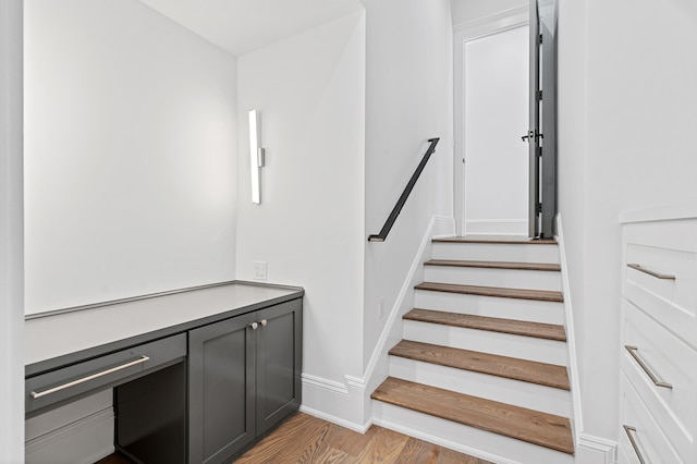 stairway featuring wood-type flooring