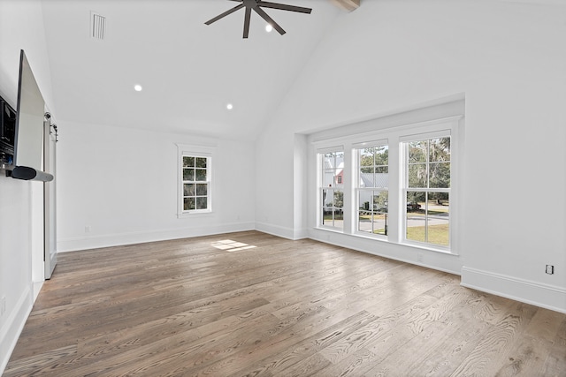 unfurnished living room featuring beamed ceiling, high vaulted ceiling, wood-type flooring, and ceiling fan