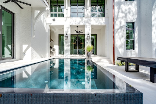 view of swimming pool featuring ceiling fan, a patio, a jacuzzi, and french doors