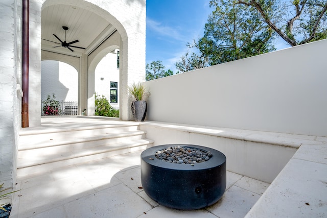 view of patio / terrace with a fire pit and ceiling fan